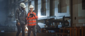 Image of two construction workers consulting